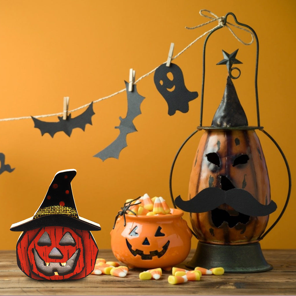 Wooden pumpkin Halloween decoration wearing a black witch hat on a wooden table