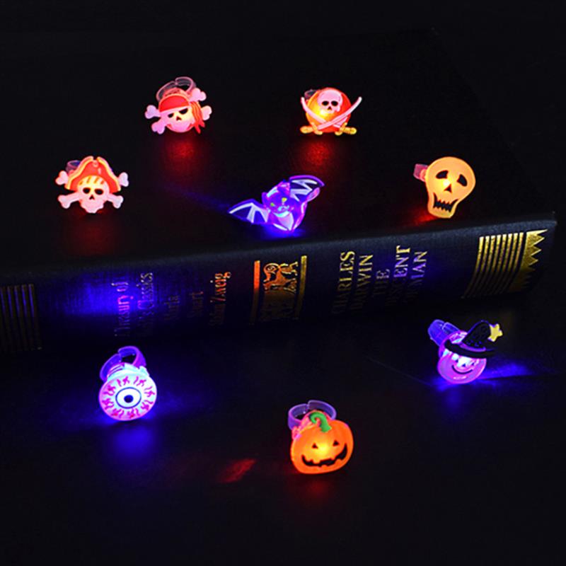Glowing Halloween brooch ring lit up against a dark background